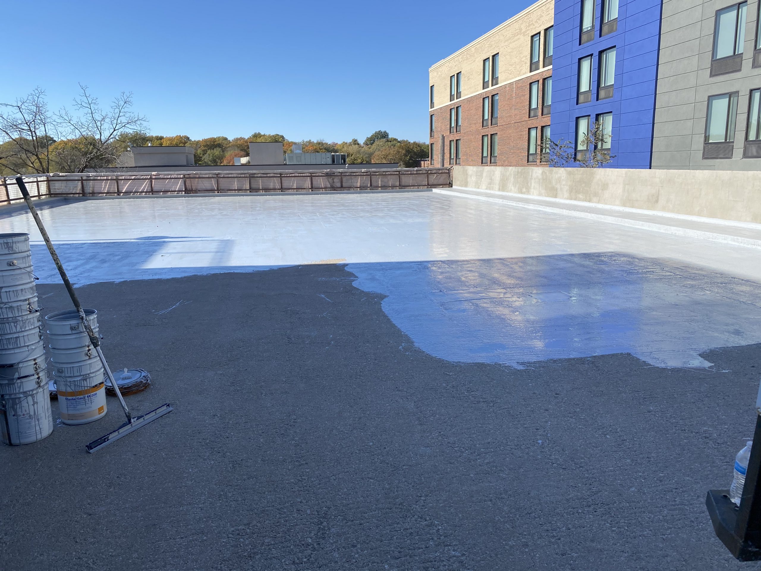 white coating being applied to a parking deck