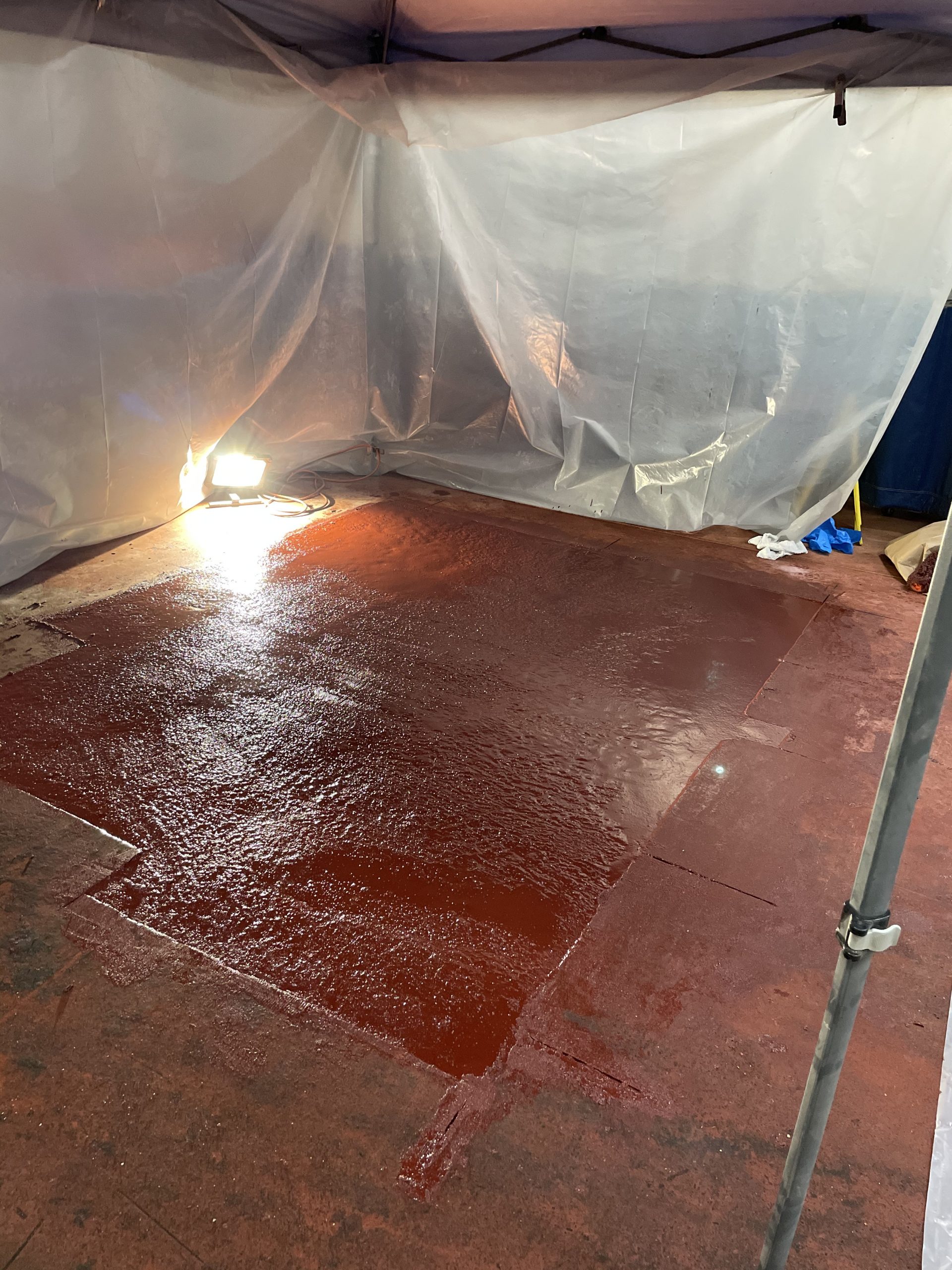 fresh coat of red epoxy floor coating and containment
