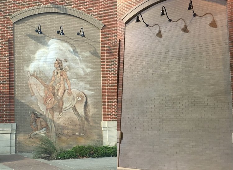 brick wall before photo with native american painting and after photo of painting removed